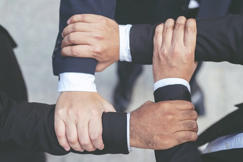 Close up of Group people of businessmen joining putting their hands together with stack of hands showing unity and teamwork. concept Success and encouragement to overcome obstacles. soft focus.